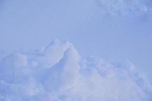 Snow surface with lumps and snowdrifts in winter. Winter snow field surface. photo