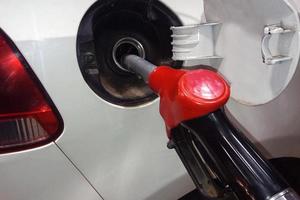 Refueling gasoline in a car tank close up photo