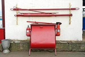 firefighting equipment stand with sandbox, extinguishers, spades and fire hooks photo