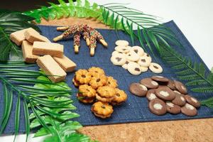 The sweets are placed on cloth and plywood decorated with leaves. photo