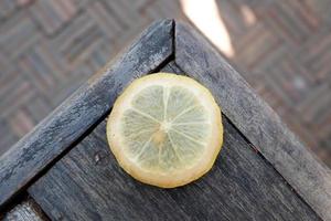 Sliced of lemon on wood table photo