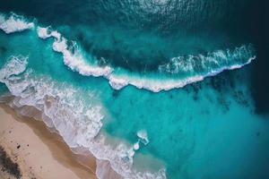 A stunning aerial shot of turquoise waters and a sandy beach, captured by a drone. The photograph showcases the beauty of the ocean and the beach, and offers a unique perspective. photo