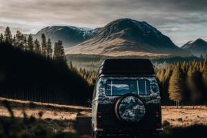 A retro campervan is parked in a beautiful, secluded spot in the great outdoors. It has a small awning and the windows are open, inviting adventurers to explore. The essence of van life. photo