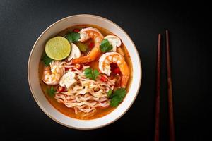 instant noodles ramen in spicy soup with shrimps or Tom Yum Kung photo