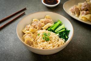 dried egg noodles with pork wonton or pork dumplings without soup photo