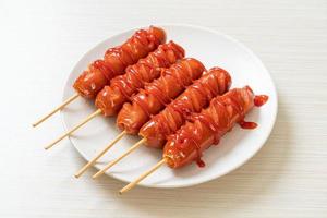 fried sausage skewer with ketchup photo