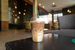 caramel macchiato coffee cup in coffee shop photo