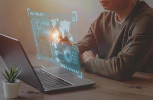 A Businessman use laptop for analyze and management data to succeed on virtual screen. photo