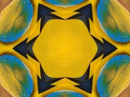 Yellow feather kaleidoscope floral pattern with some blue and red color. Abstract unique and aesthetic background. photo