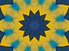 Yellow feather kaleidoscope floral pattern with some blue and red color. Abstract unique and aesthetic background. photo