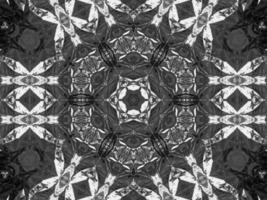 Black silver metalic kaleidoscope background. Abstract and symmetric pattern with dark vibes. photo