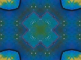 Yellow feather kaleidoscope floral pattern with some blue and red color. Abstract unique and aesthetic background. photo