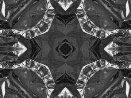Black silver metalic kaleidoscope background. Abstract and symmetric pattern with dark vibes. photo
