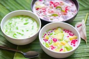 Thai dessert - Thai rice flour pandan leaf cantaloupe jelly mixed fruit with coconut milk and syrup sweets dessert on bowl, Asian food - top view photo