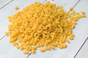 Pasta background, raw macaroni on background, close up raw macaroni pasta uncooked delicious pasta for cooking food