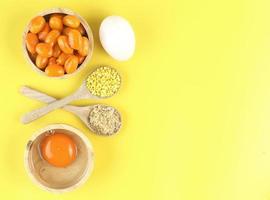 Top view of Thai dessert and ingredient - Mung bean paste formed in egg yolk and sugar on yellow background photo