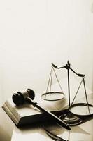 Justice and law concept.Male judge in a courtroom with the gavel, working with, computer and docking keyboard, eyeglasses, on table in morning light photo