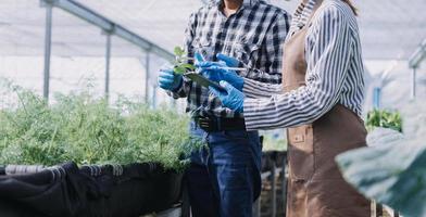Futuristic businessman farms vegetables and crops using modern AI technology using mobile phones, temperature and humidity sensors, water tracking, climate control, holographic data data icons. photo