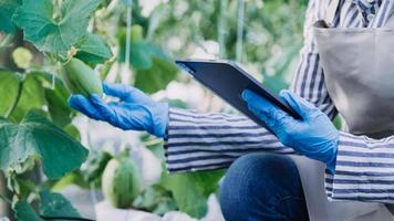 Futuristic businessman farms vegetables and crops using modern AI technology using mobile phones, temperature and humidity sensors, water tracking, climate control, holographic data data icons. photo