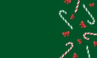 Green background with striped red and green candy canes and red bows with copy space photo