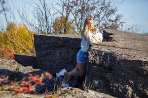 aerial view on girl stays on rock or concrete ruined structure photo