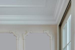 Detail of corner ceiling with intricate crown molding. photo