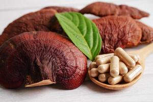 Lingzhi or Reishi mushroom with capsules, organic natural healthy food. photo