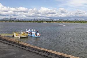 Passenger boats cross the Mekong River between Thailand and Laos at Nakhon Phanom Province, Thailand. photo