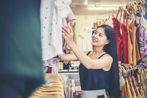 Beautiful women shopping for trendy clothes in the boutique. photo