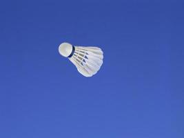 A soccer ball shot in the air with blue sky background photo