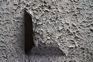 Detailed view on aged concrete walls with cracks and a lot of structure in high resolution photo