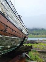 un viejo barco abandonado en la costa de islandia. foto