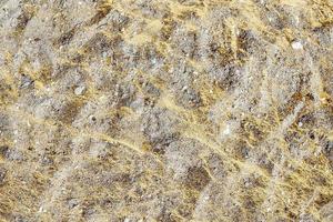 Detailed close up view on a brown sand ground texture photo