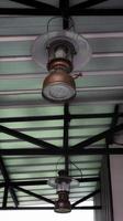 Vintage old hanging storm lantern at the ceiling. photo