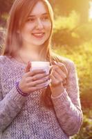 Girl holding a cup of coffee photo