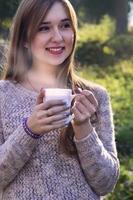 Girl holding a cup of coffee photo