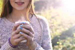 Girl holding a cup of coffee photo