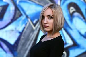 Portrait of a young blond girl with short hair on a background o photo