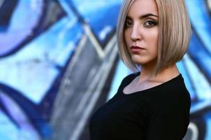 Portrait of a young blond girl with short hair on a background o photo