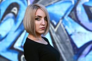 Portrait of a young blond girl with short hair on a background o photo