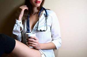 Young nurse girl sitting with coffee cup photo