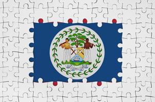 Belize flag in frame of white puzzle pieces with missing central part photo