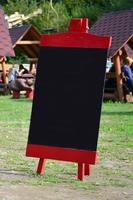 A large board as a menu for an open-air restaurant in a mountainous area. Free space for your text photo