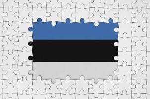 Estonia flag in frame of white puzzle pieces with missing central part photo