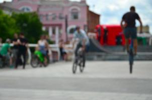 Defocused image of a lot of people with bmx bikes. Meeting of fans of extreme sports photo