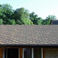 Modern roofing and decoration of chimneys. Flexible bitumen or slate shingles photo