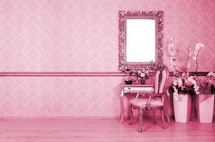 A fragment of a retro interior with a chair and table, on which is a telephone and a vase of flowers. Image toned in Viva Magenta, color of the year photo