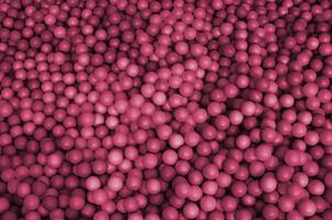 Many plastic balls in a kids ballpit at a playground Image toned in Viva Magenta, color of the 2023 year photo