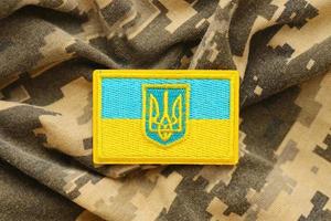 Military camouflage fabric with ukrainian flag on uniform chevron photo