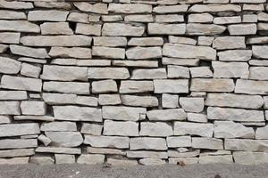 Texture of a stone wall background from small stones photo